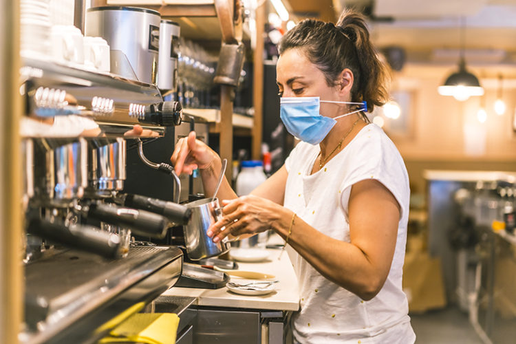 waitress-with-face-mask-in-bar-making-coffee-with-milk-with-the-coffee-machine-one-spring-morning